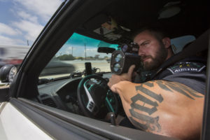 APD Officer Jason Borne monitors Highway 183 north of I-35 for traffic violations. His boss, Commander Art Fortune, wants more money for enforcement in the city's Vision Zero plan. CREDIT MIGUEL GUTIERREZ JR./ KUT NEWS 