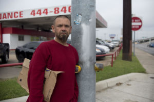 Robert Lormond, who is experiencing homelessness, stands at Ben White and Manchaca. He says he almost gets hit by a car daily. CREDIT MIGUEL GUTIERREZ JR./ KUT NEWS