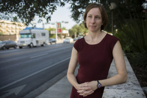 Jen Duthie stands at the intersection of intersection of West Dean Keeton and Guadalupe. Photo by Miguel Gutierrez Jr. /KUT News.