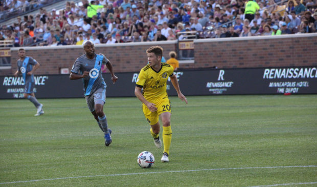 two people playing soccer